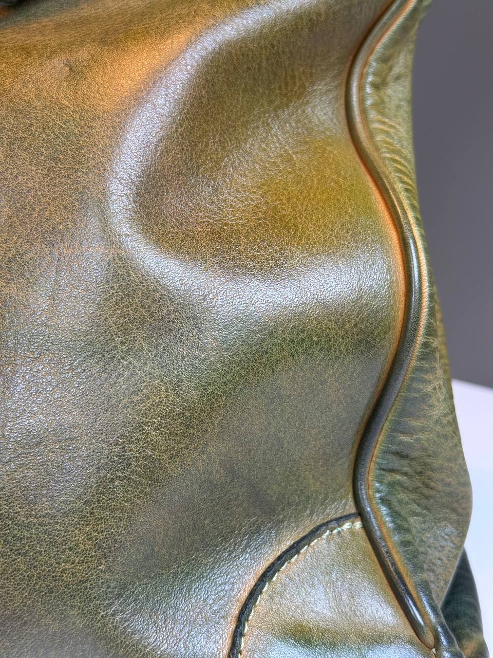 Green washed leather bag with handmade finished color