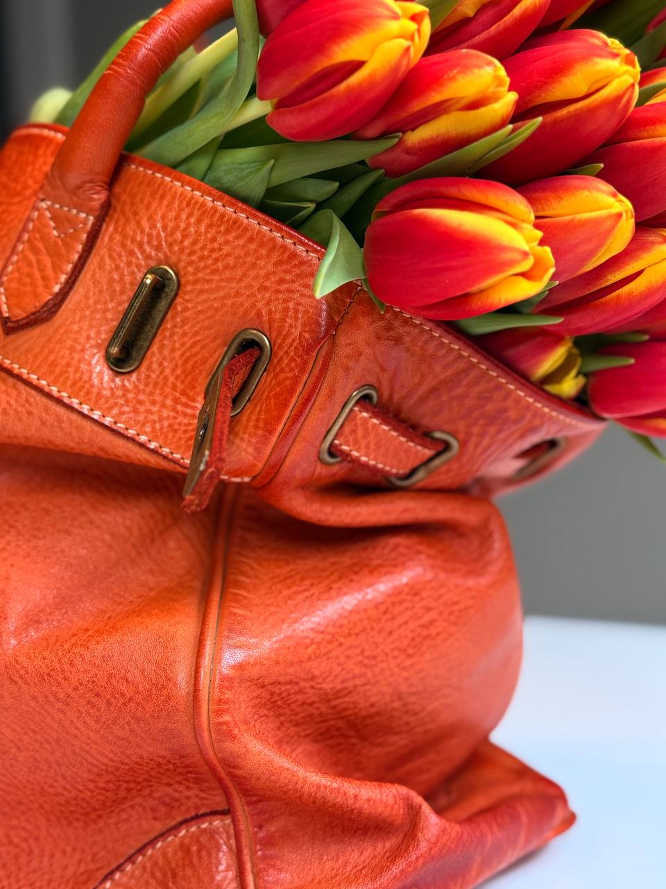 Orange washed leather bag with handmade finished color