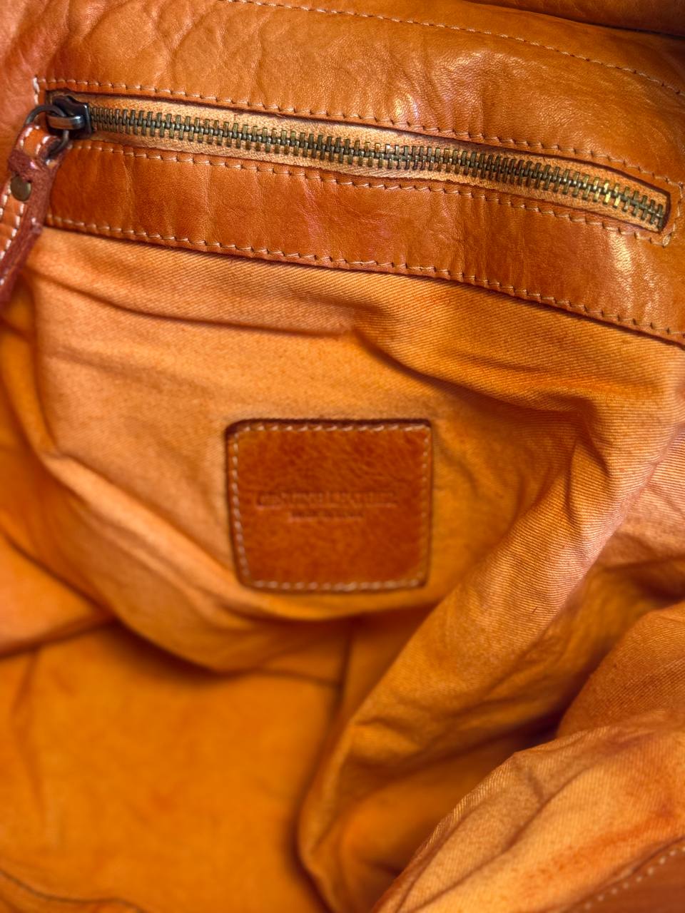 Orange washed leather bag with handmade finished color