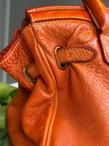 Orange washed leather bag with handmade finished color