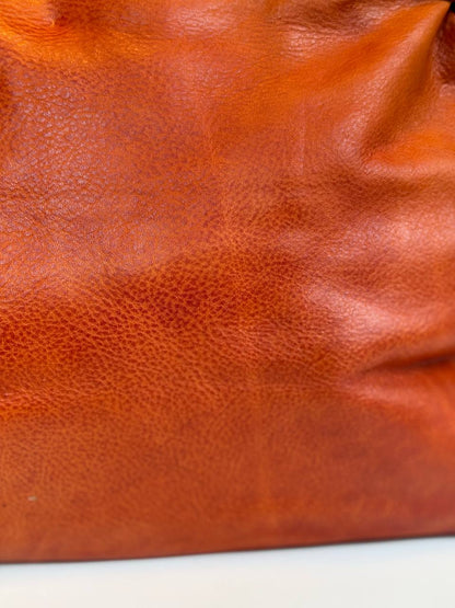 Orange washed leather bag with handmade finished color