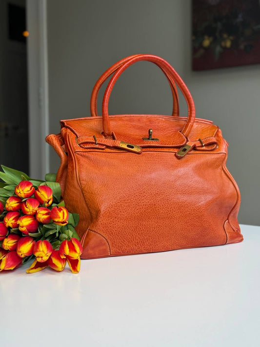 Orange washed leather bag with handmade finished color