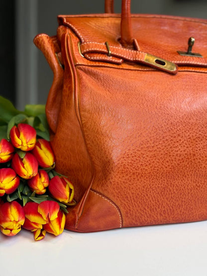 Orange washed leather bag with handmade finished color